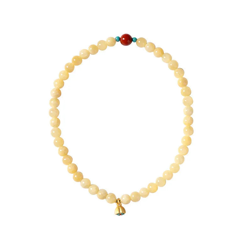 Yellow jade coloured topaz bracelet with double ring design and lotus seedpod beads