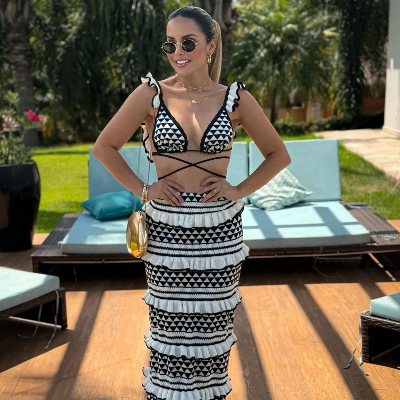 Women's black and white striped bikini set with ruffled spaghetti straps and matching long knitted cotton skirt
