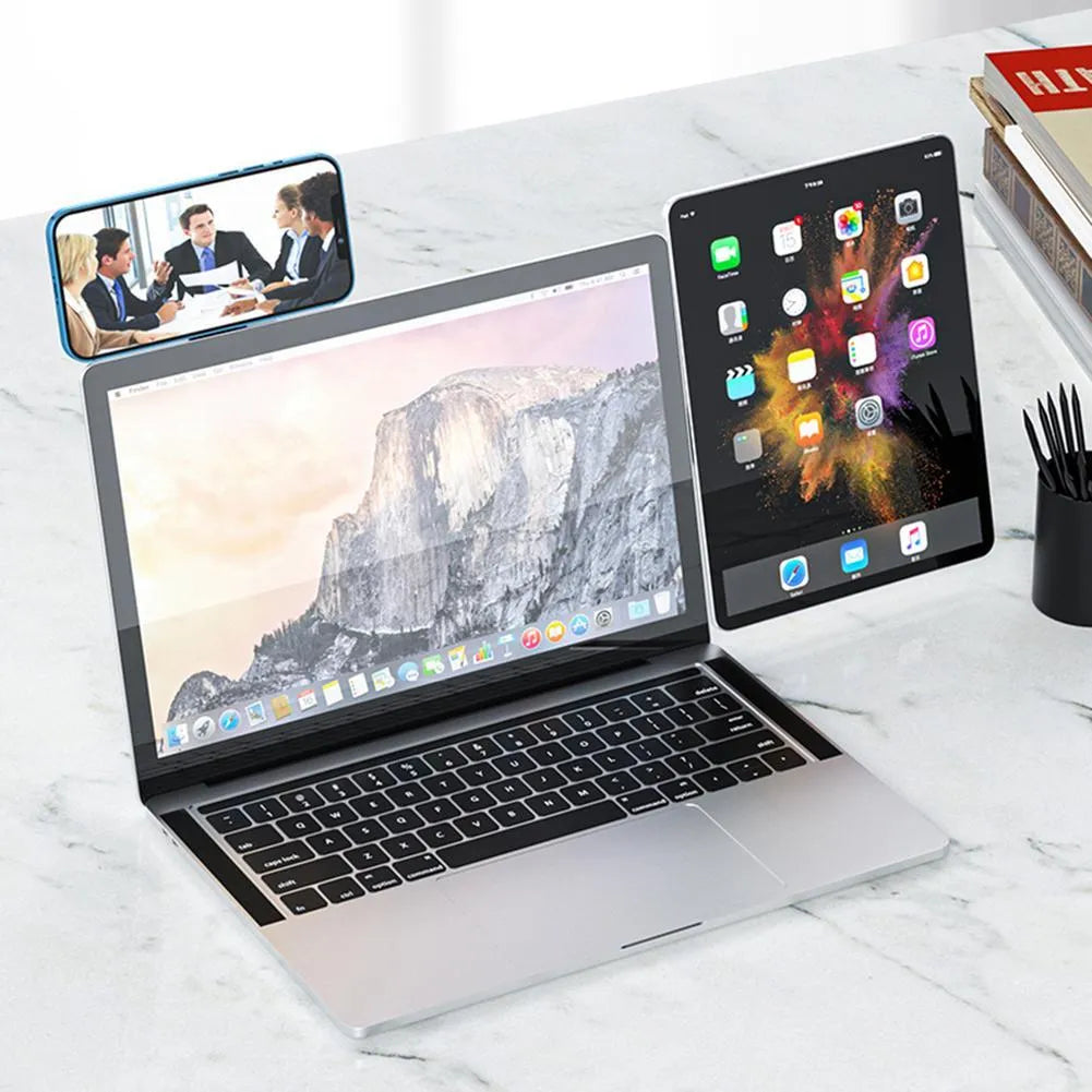 Black magnetic laptop phone holder clip attached to a monitor with a smartphone mounted.