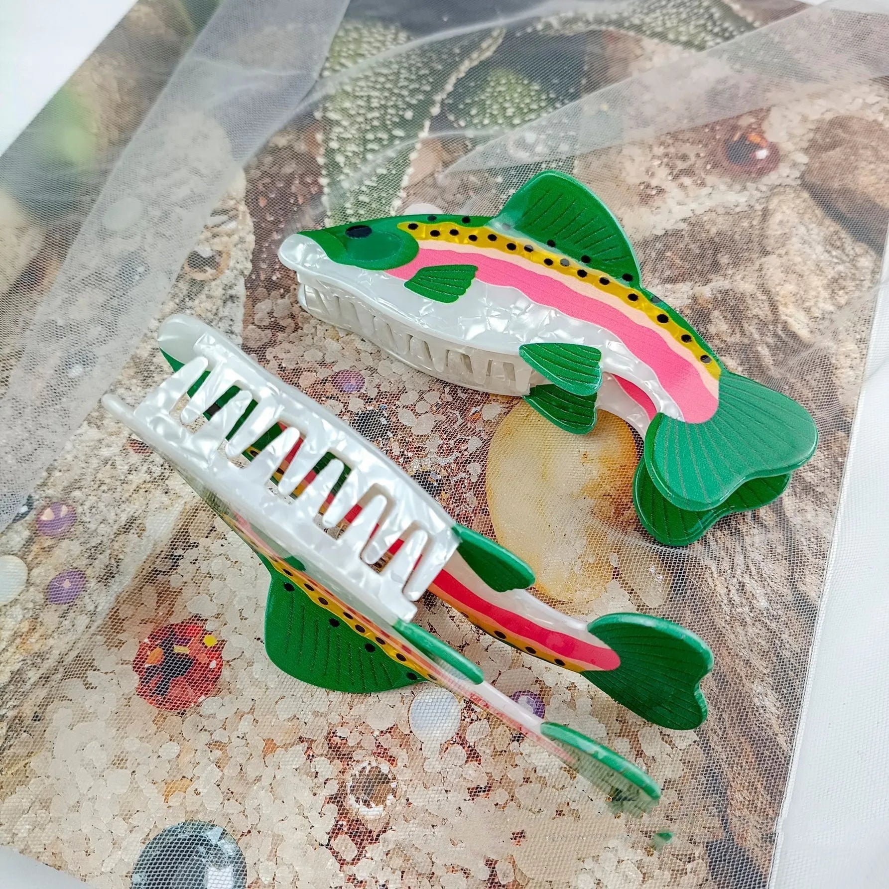 Dark green PVC hair clip with a printed design of a rainbow trout and a carp.