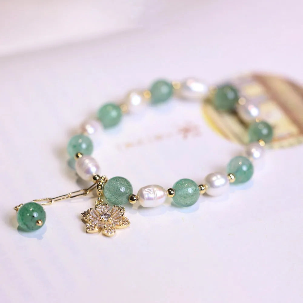 Green freshwater pearl bracelet with Chinese knot design and strawberry pearl hanging detail