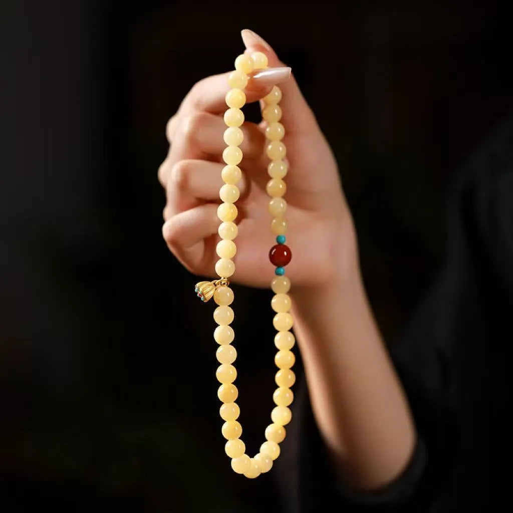 Yellow jade coloured topaz bracelet with double ring design and lotus seedpod beads