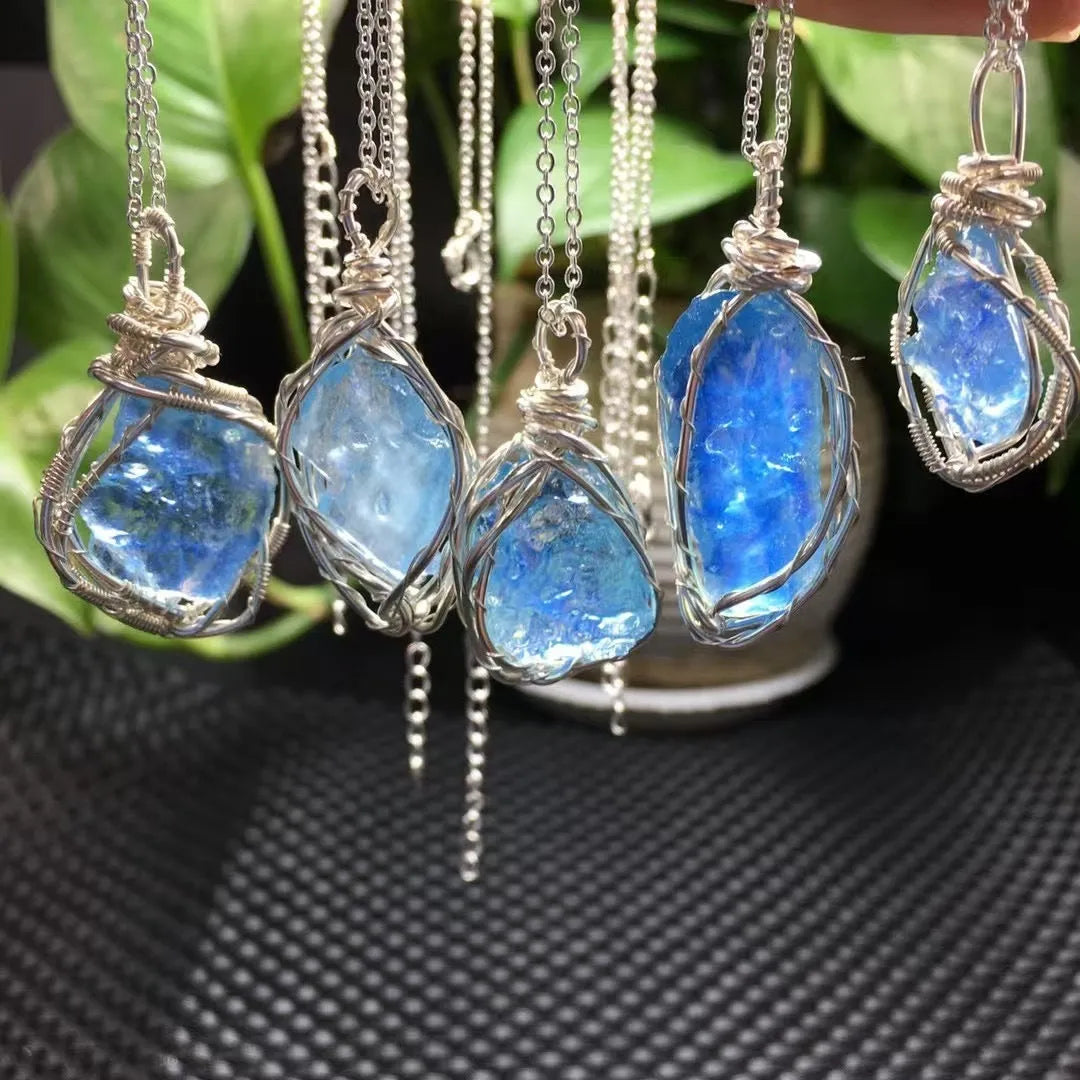 Natural raw aquamarine stone pendant hand-wrapped in gold copper wire with starry sky design