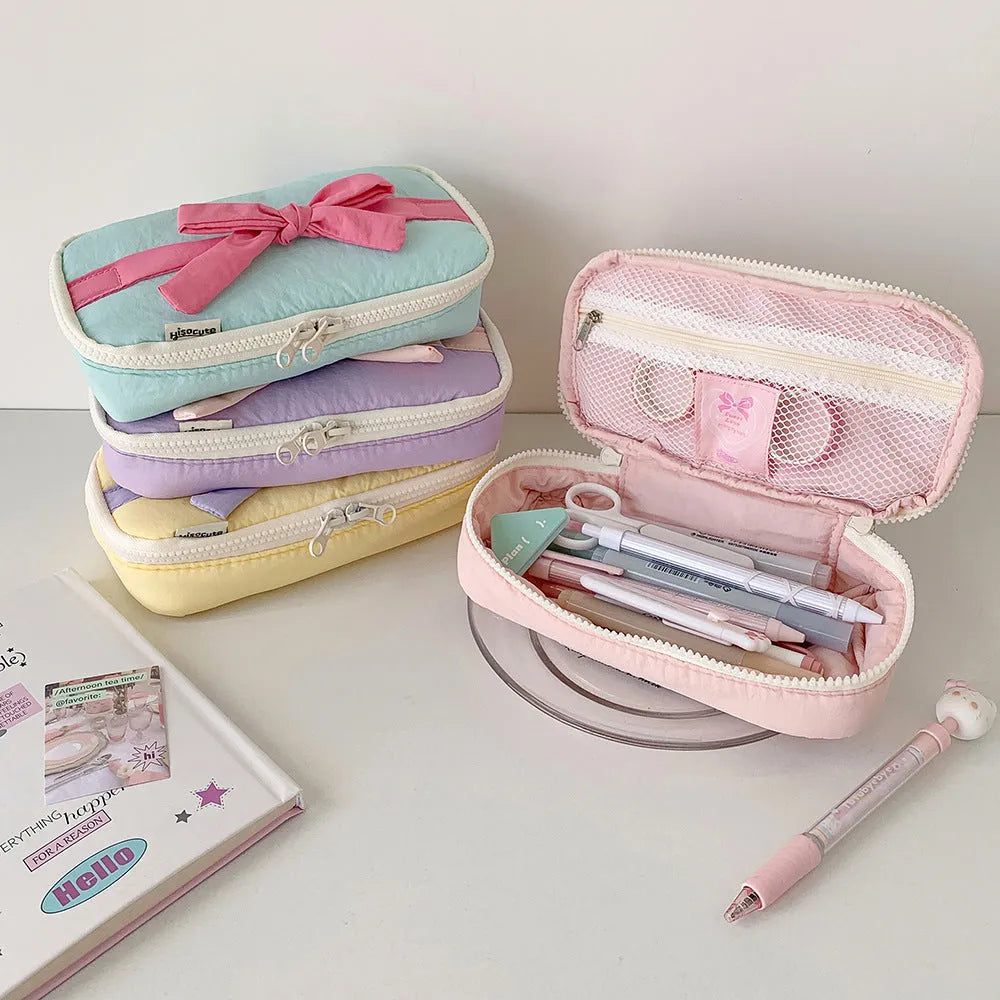Soft polyester cotton pencil case with minimalist bow design, available in six colours including pink, black and yellow