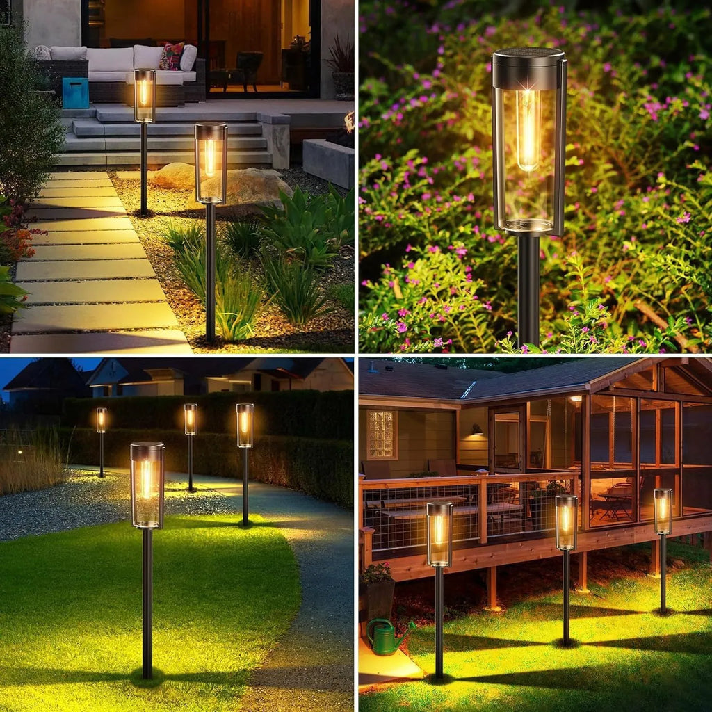 Round tungsten wire solar lawn lamp on grass in a garden courtyard emitting warm light