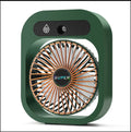 Green and white USB portable misting fan humidifier on a desk showing adjustable vent and water tank.