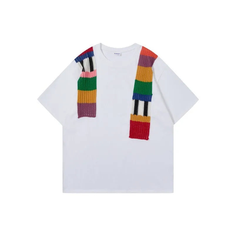 Men's loose fit grey T-shirt with a black and white patchwork letter design on the chest.