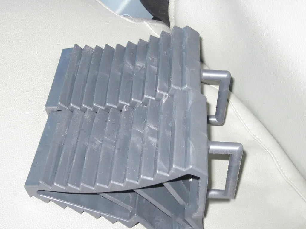 Car tyre skid stop parking locator set showing triangular anti-slip devices in black and silvery colours