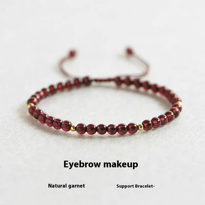 Hand-woven garnet bracelet with red rope and flexible wire construction showing national tide style