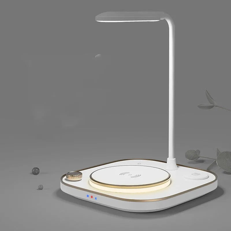 Black three-in-one wireless charging station with 15W fast charging and optional desk lamp on a wooden desk.