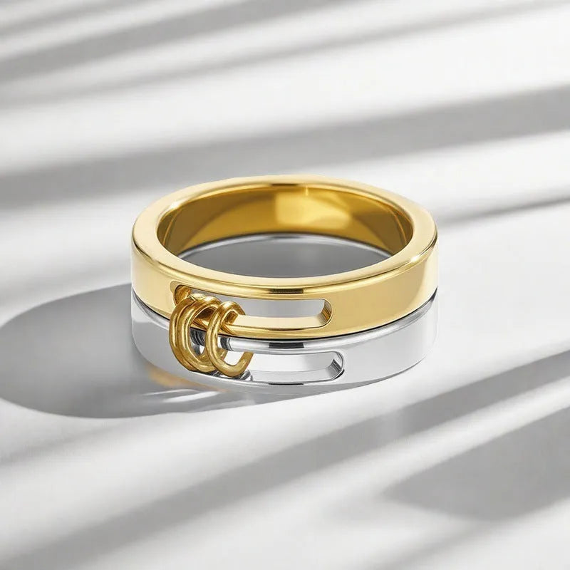 Gold double-layer twin ring made of titanium steel on a plain background