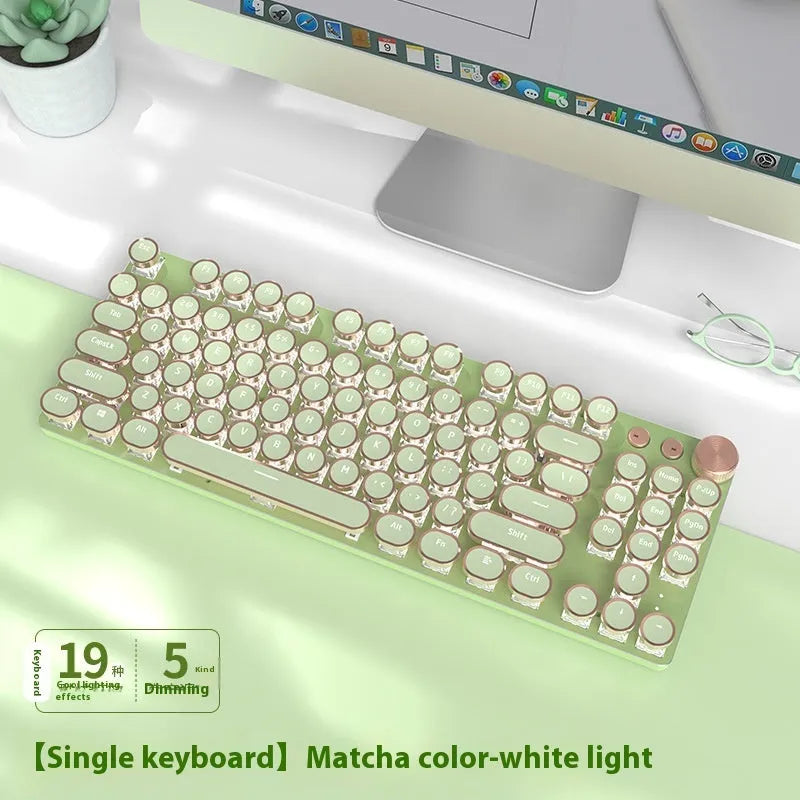 Matcha green 87-key mechanical gaming keyboard with aluminium frame and white backlighting on a desk.