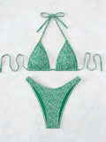 Women's floral pattern halter lanyard bikini set in emerald green, shown with top and shorts.