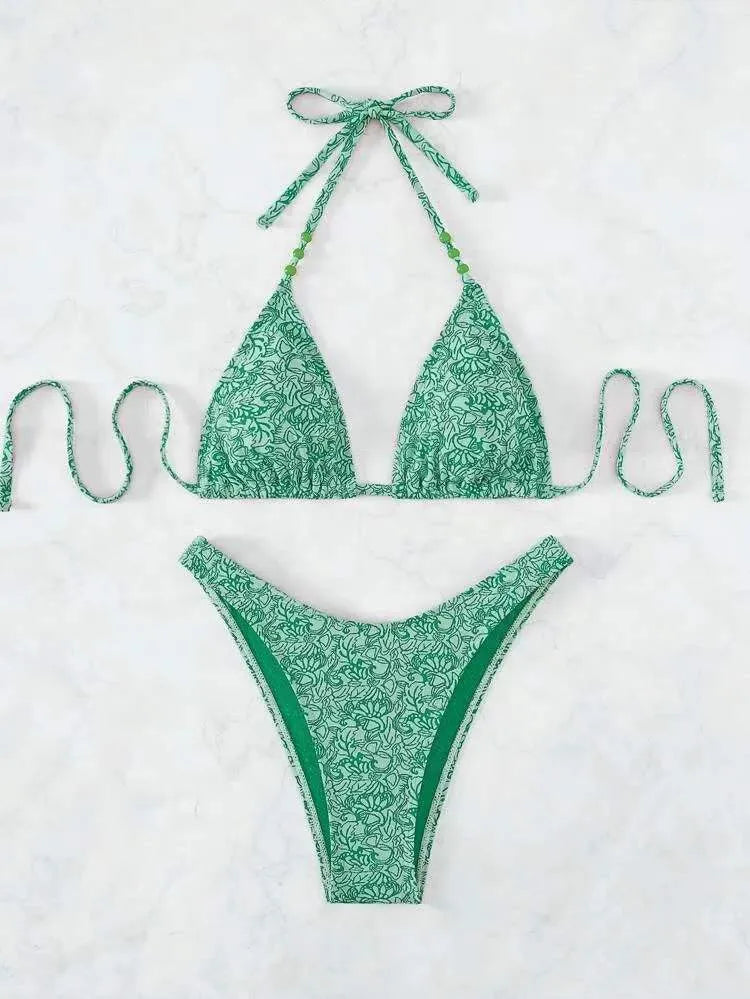 Women's floral pattern halter lanyard bikini set in emerald green, shown with top and shorts.