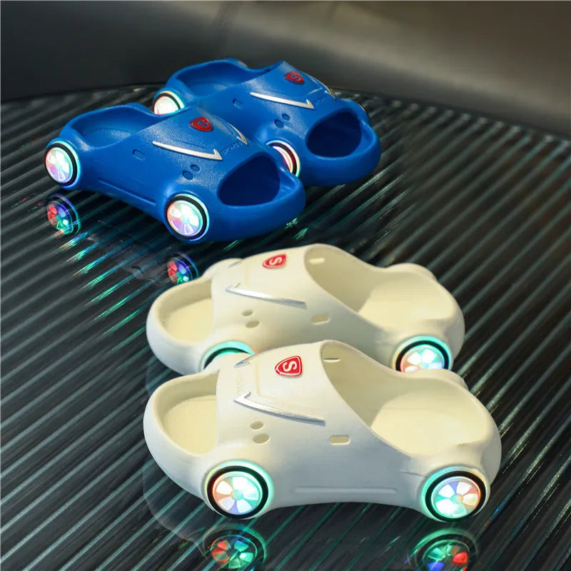 Children's luminous cartoon car design sandals with anti-slip soles on a blue background.