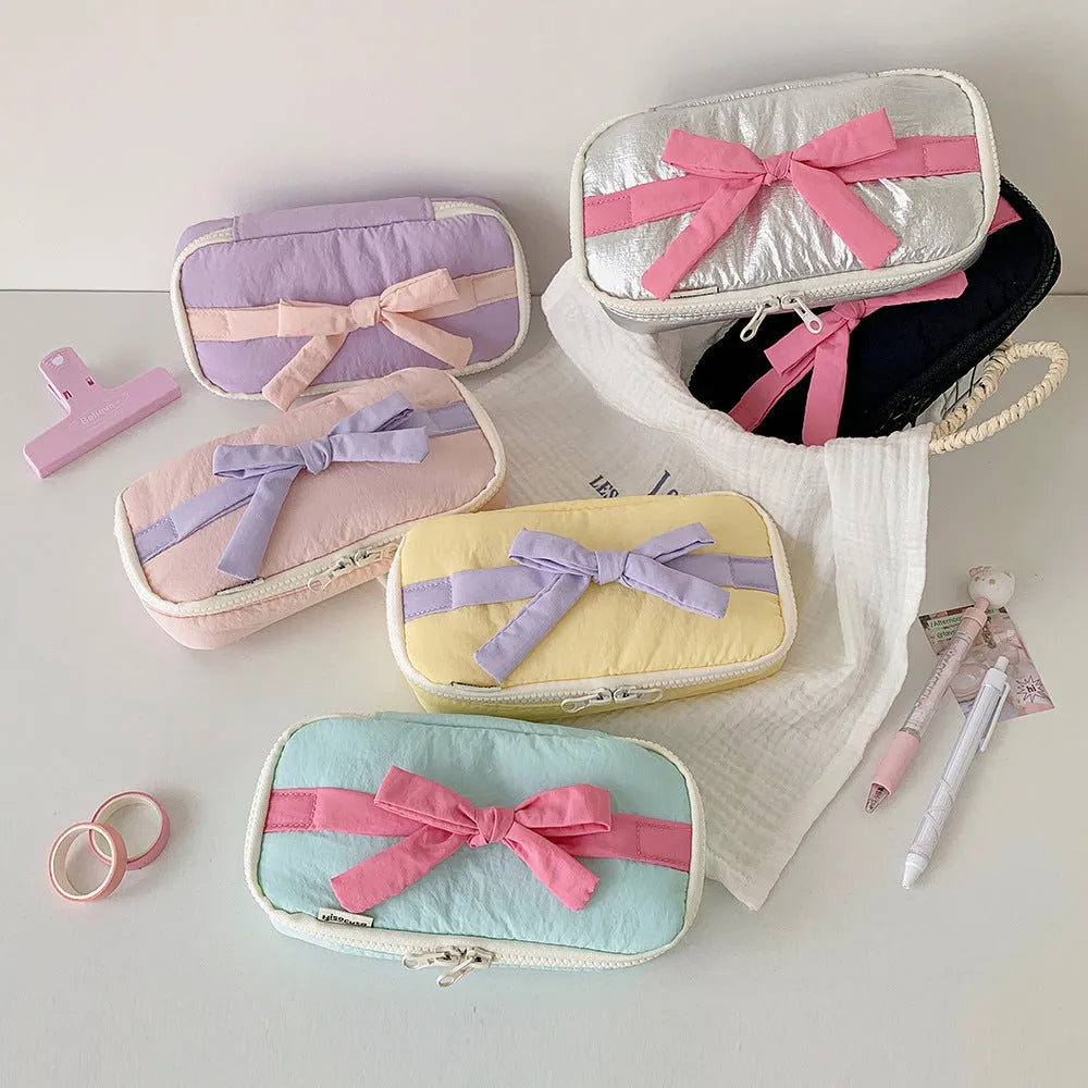 Soft polyester cotton pencil case with minimalist bow design, available in six colours including pink, black and yellow