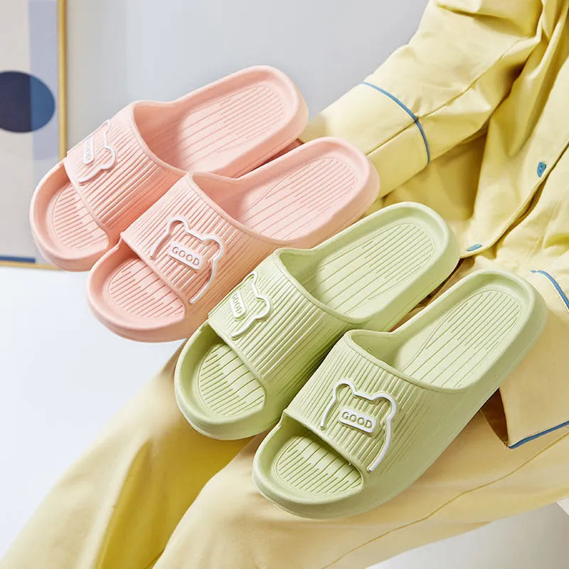 Unisex cartoon bear EVA slippers in light green with open toe and flower detail for bathroom use