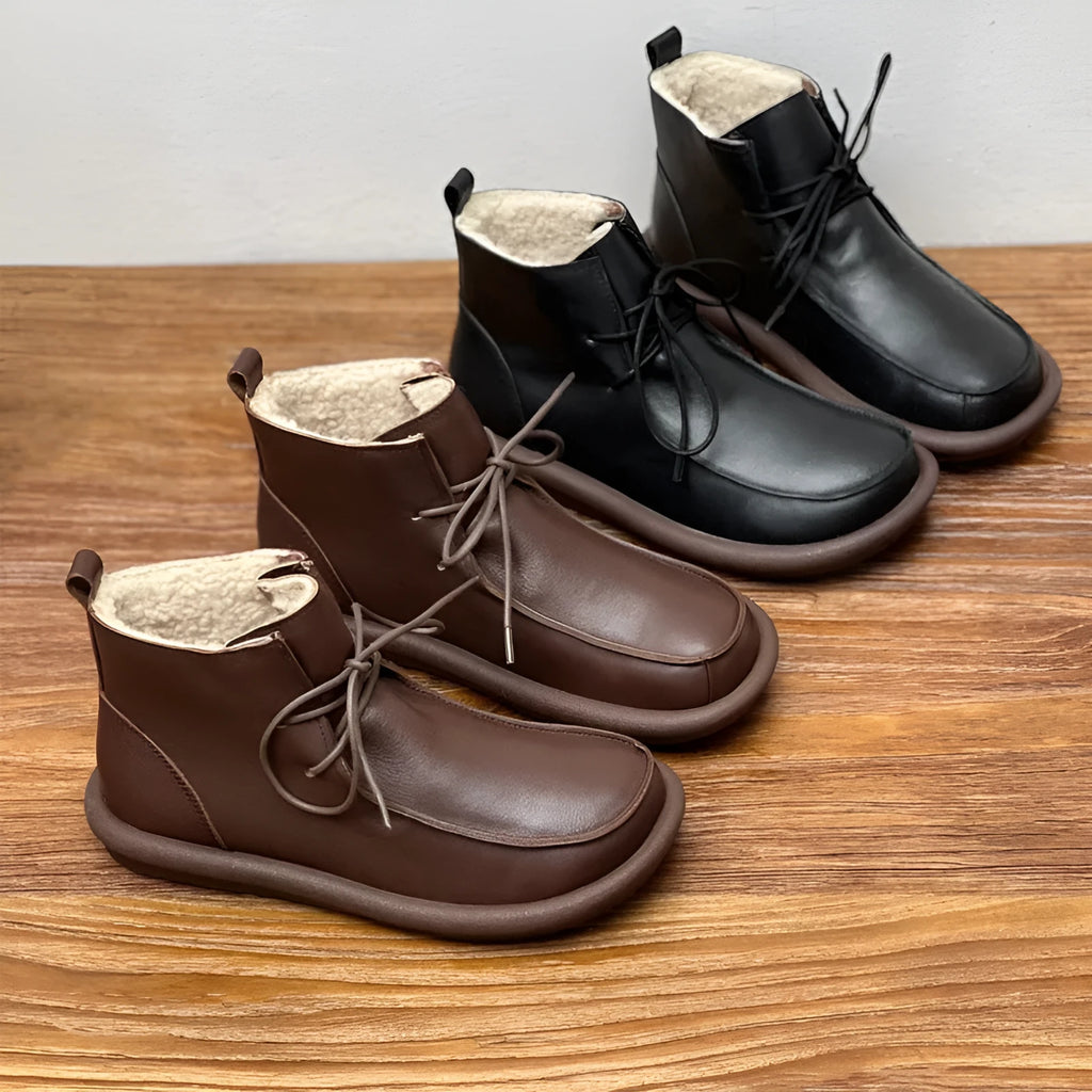 Women's black cowhide ankle boots with velvet lining, flat heel, and round toe