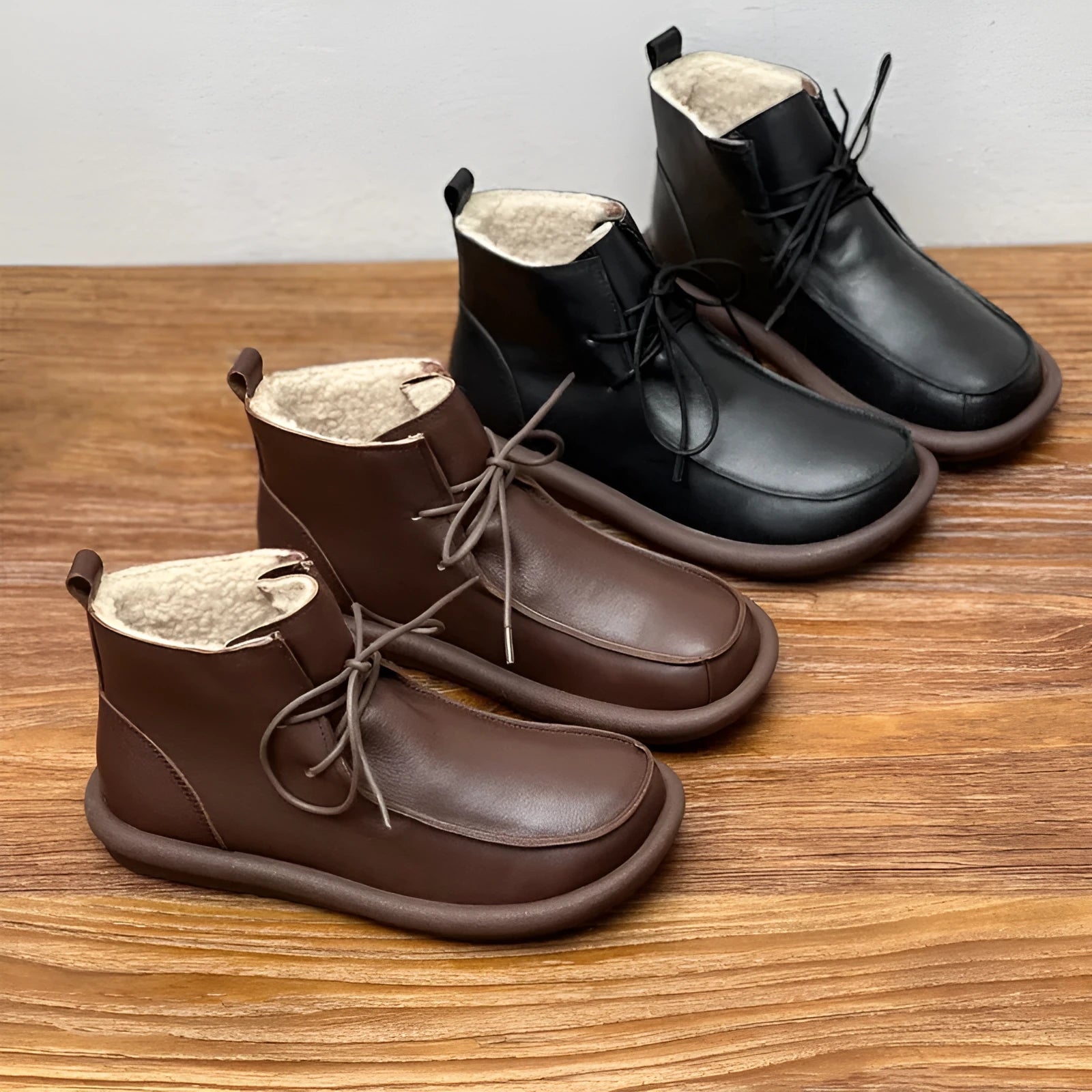 Women's black cowhide ankle boots with velvet lining, flat heel, and round toe