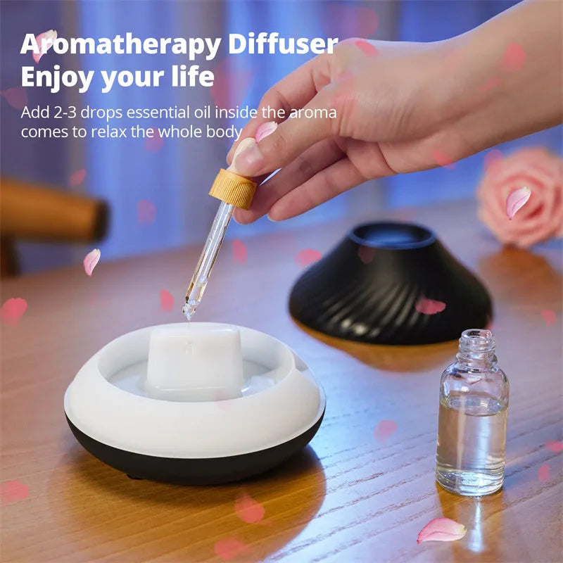 Beige USB aroma diffuser with flame-effect mist and colour-changing night light on a wooden table.
