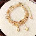 Women's natural citrine crystal bracelet with caramel layers and Saturn ring charm in gold finish
