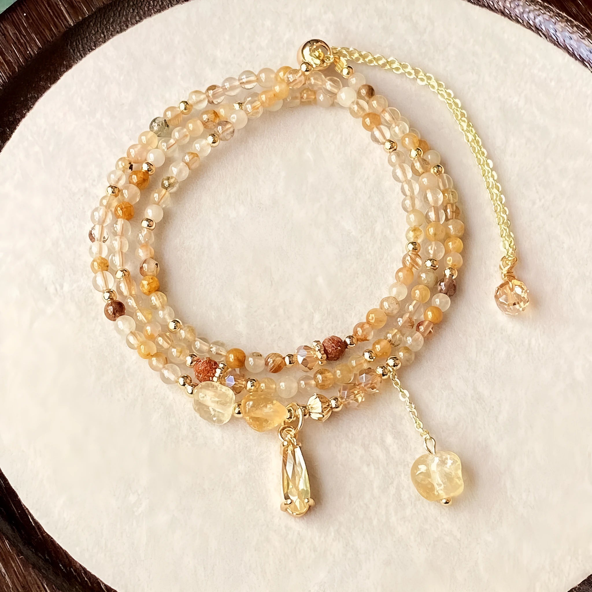 Women's natural citrine crystal bracelet with caramel layers and Saturn ring charm in gold finish