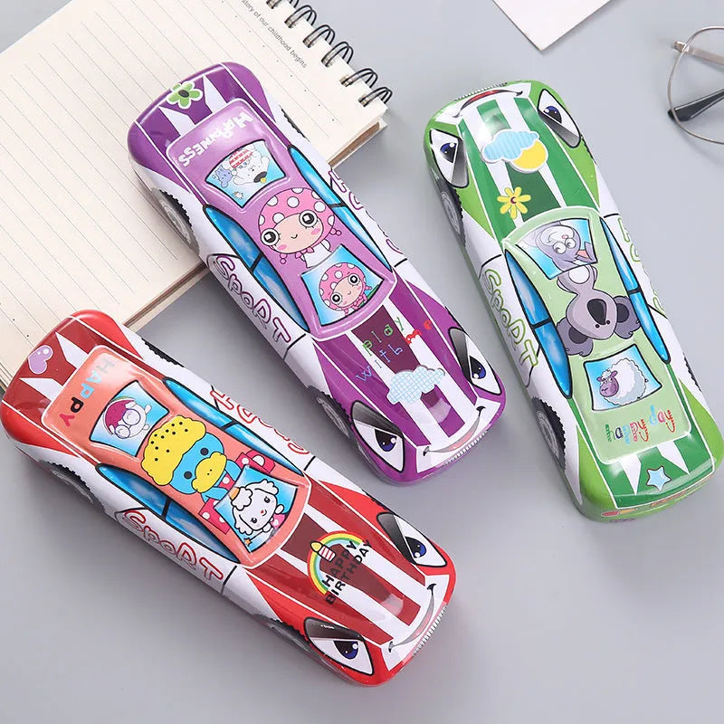 Metal tinplate stationery box with racing car trolley cartoon pattern, shown closed.