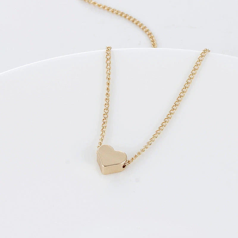 Elegant gold-tone double-sided love pendant necklace with clavicle chain, a versatile accessory for any outfit