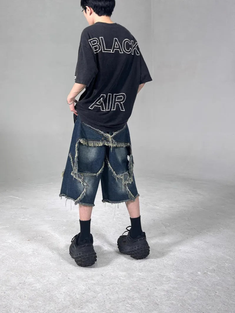 Blue denim shorts with frayed detailing and five-pointed star design in loose fit style