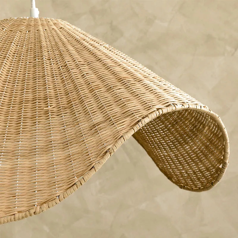Handmade natural bamboo rattan pendant light chandelier with a woven lampshade emitting a warm glow.