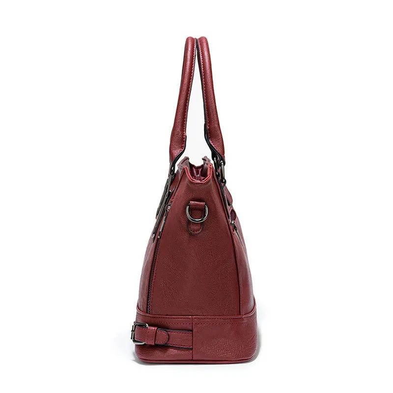 Women's PU leather handbag in black, horizontal square shape, with crossbody strap and sewing line detail