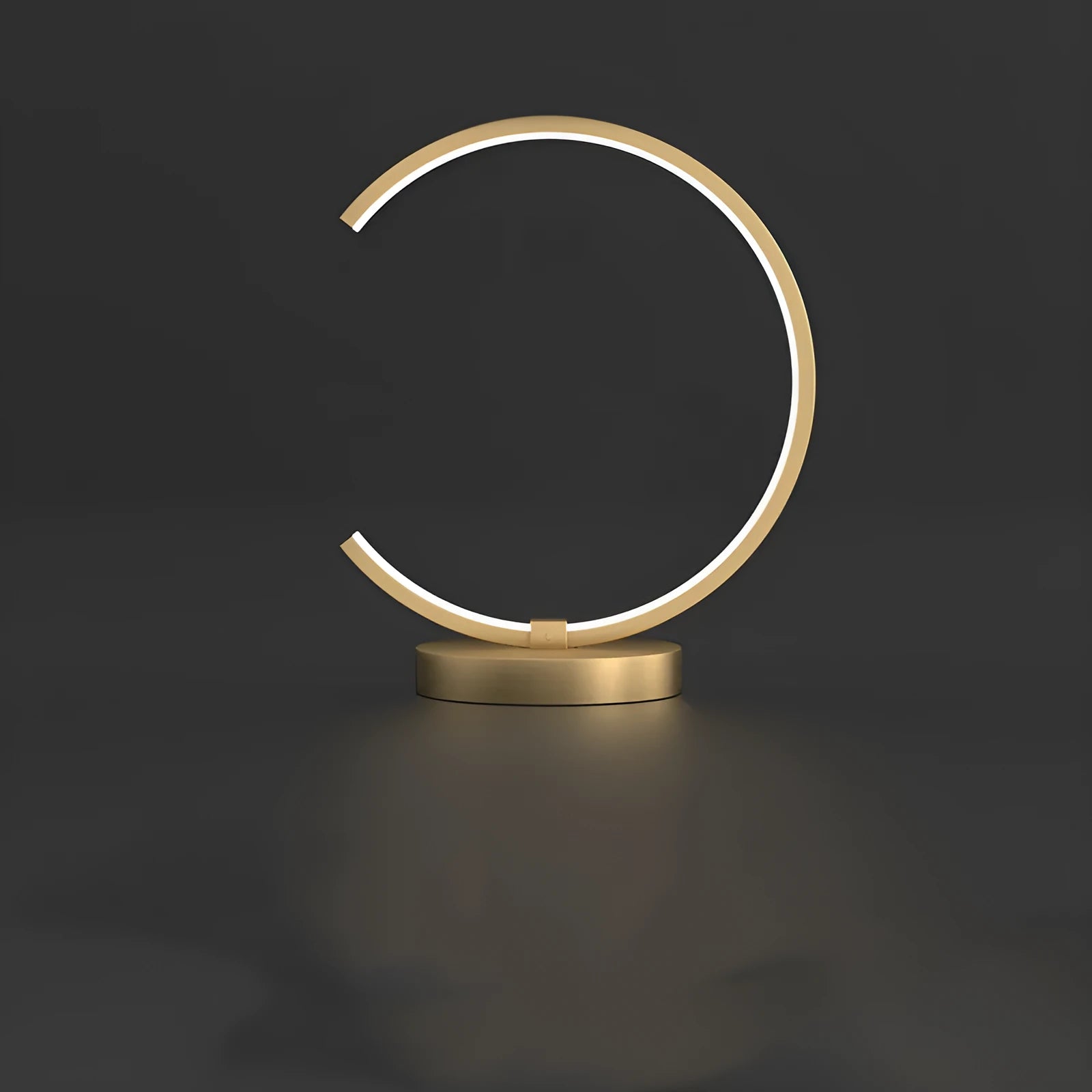 All copper Nordic style table lamp with tri-tone LED light, push button switch, on a wooden desk