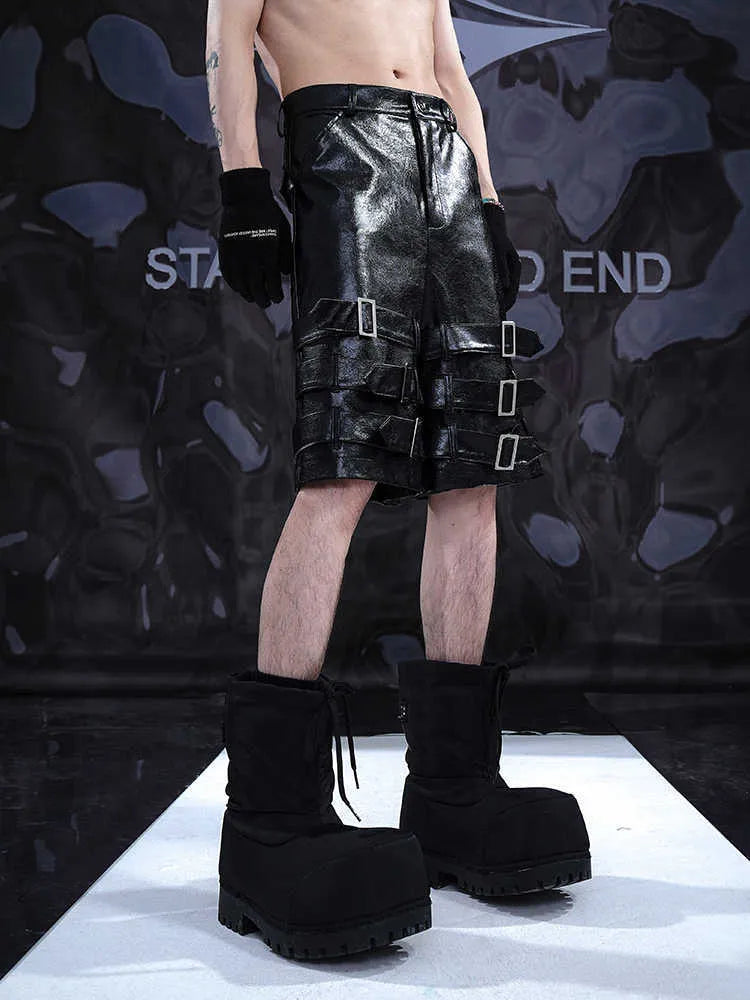 Black men's PU leather cropped shorts with leather ring detailing on a model