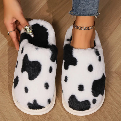 Cozy cow-print plush slippers with soft, fluffy material and non-slip soles for warm, comfortable indoor wear