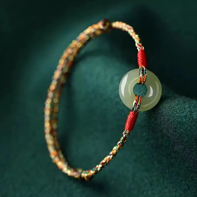 Colourful woven rope bracelet with silver peace buckle clasp on wrist