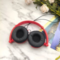 Portable over-ear wired headphones with folding design and adjustable headband in black, red or white colours