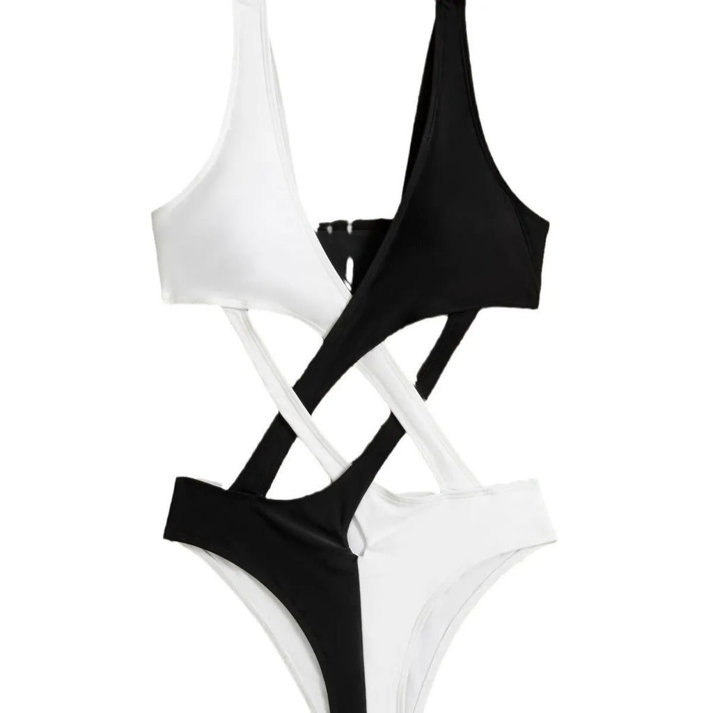White women's one-piece swimsuit with colour-block panels and hollow-out decorative sections.