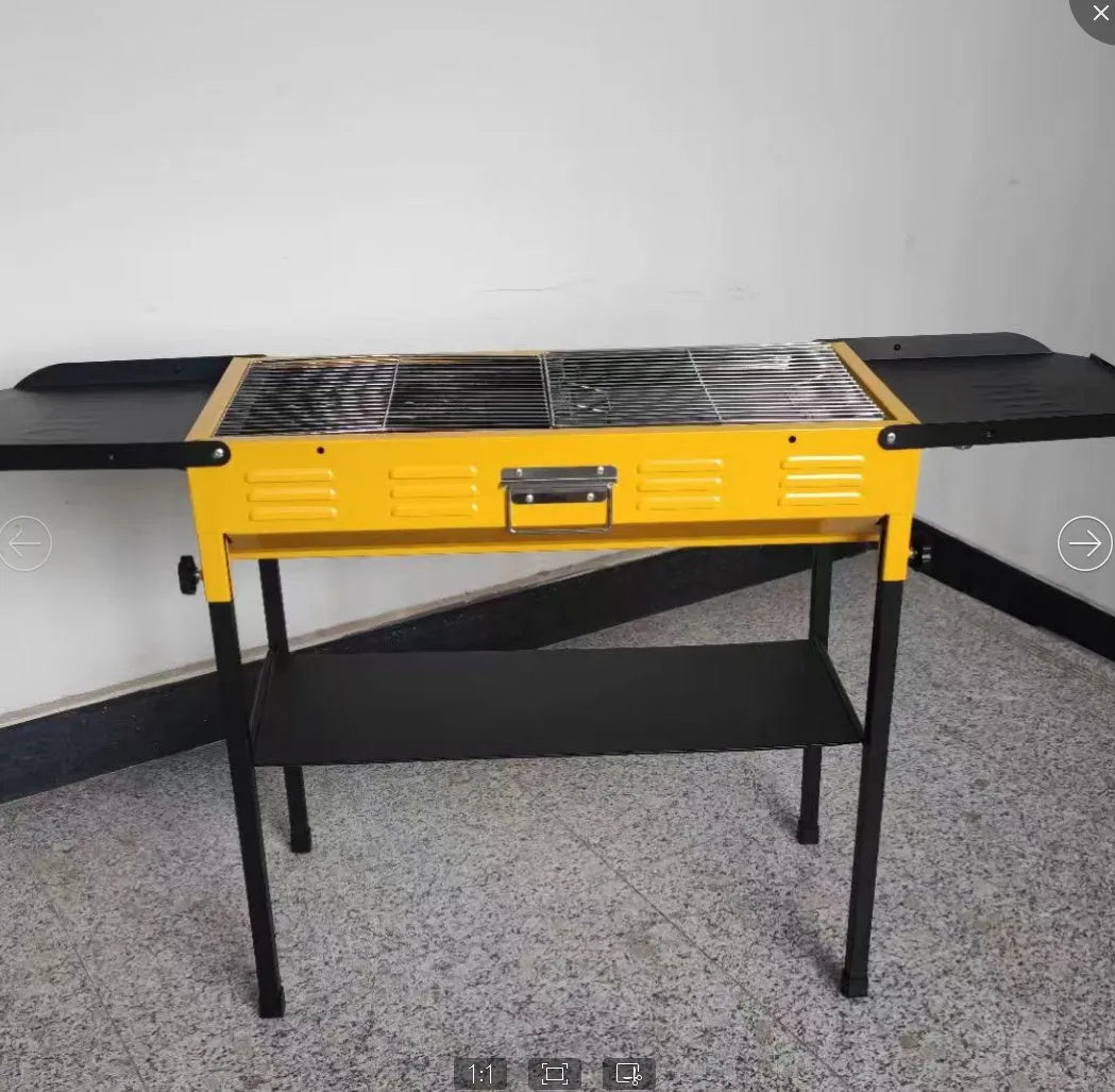 Outdoor portable metal charcoal grill with grilling grate in garden setting