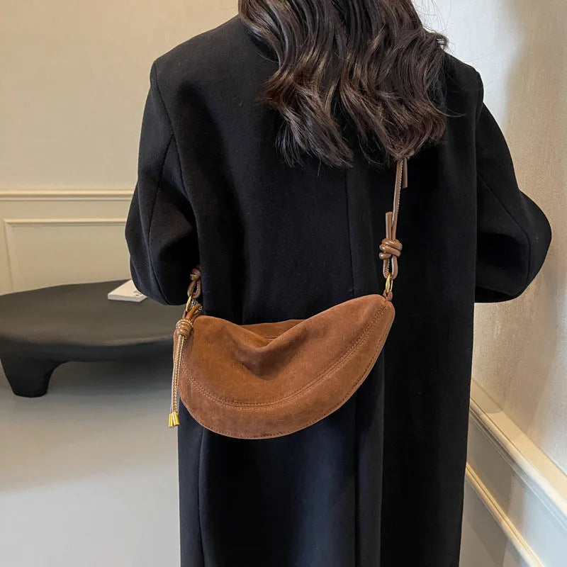 Soft PU leather crossbody underarm dumpling bag in black with sewing line detail and sandwich pocket