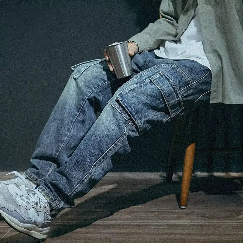 Man wearing blue loose straight-leg retro jeans with a zip fly, showcasing the casual fit.