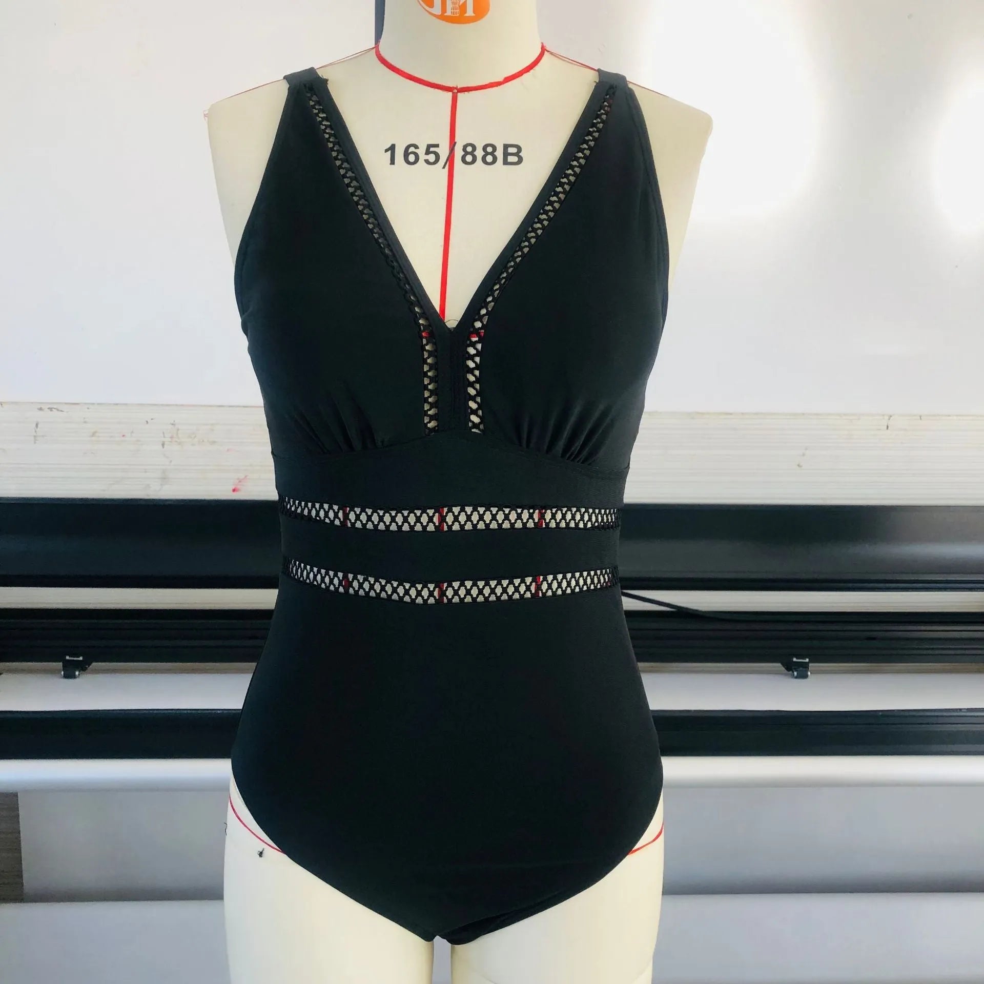 Black printed plus size women's bikini swimsuit with mesh stitching, shown on a model.