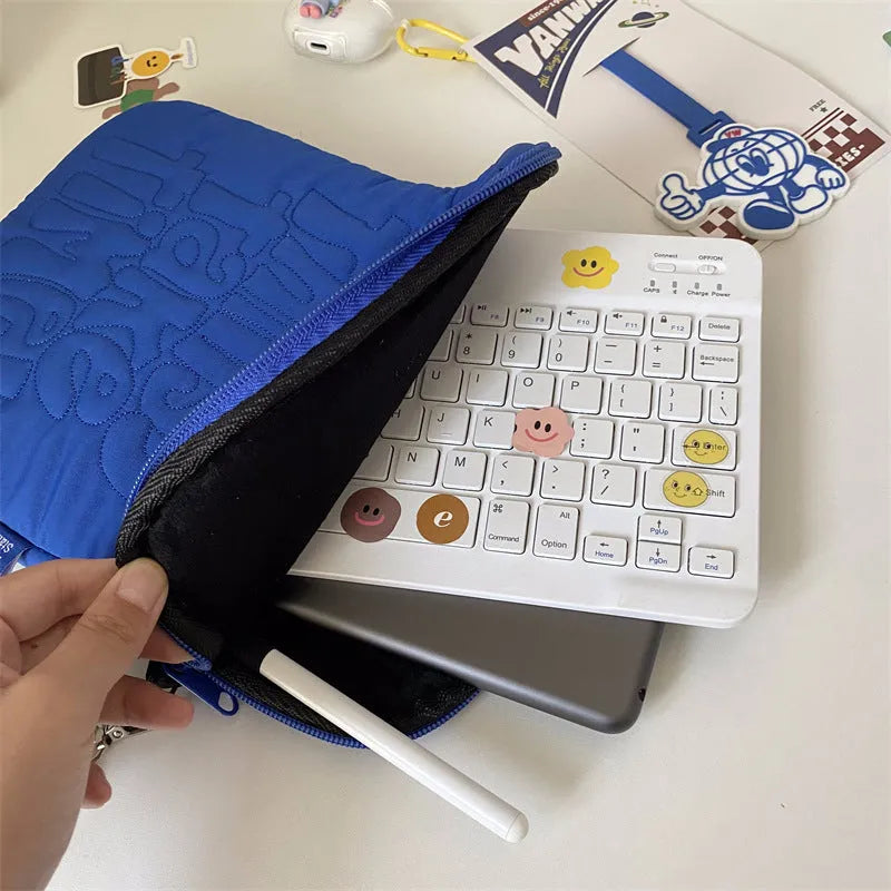 Embroidered blue silk laptop liner bag with letter pattern and cotton lining on a white background