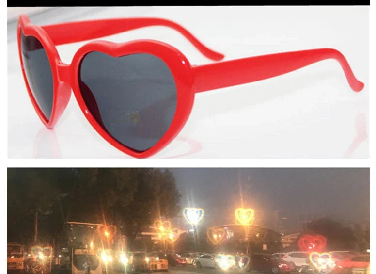 Heart-shaped glow-in-the-dark sunglasses in various vibrant colors, featuring a durable plastic frame and resin lenses for reliable UV protection.