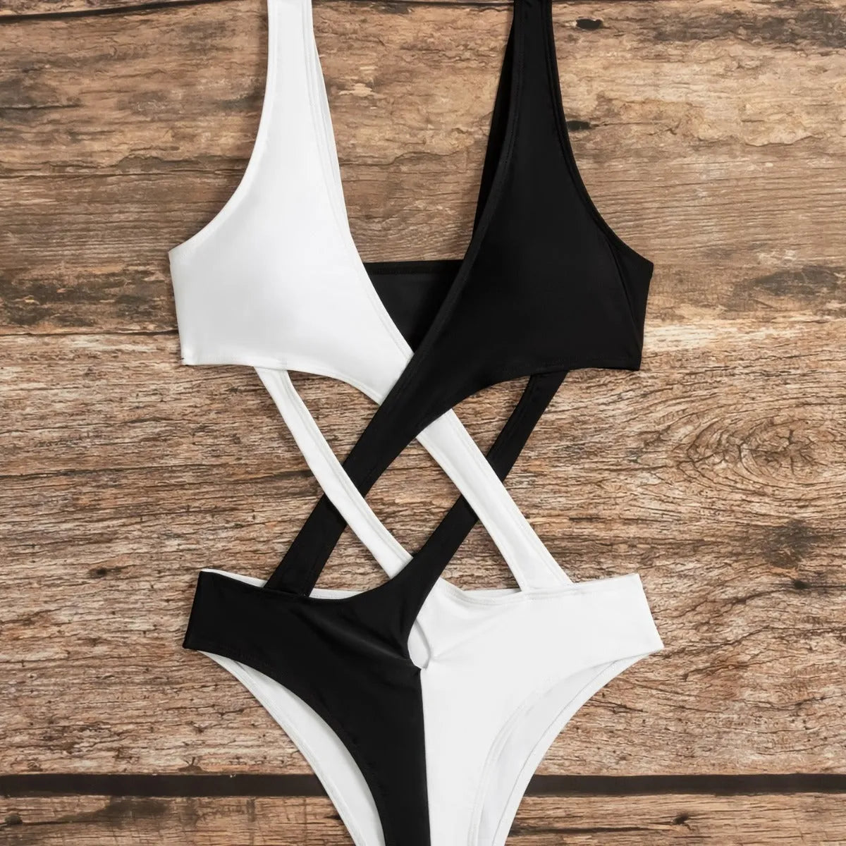 White women's one-piece swimsuit with colour-block panels and hollow-out decorative sections.