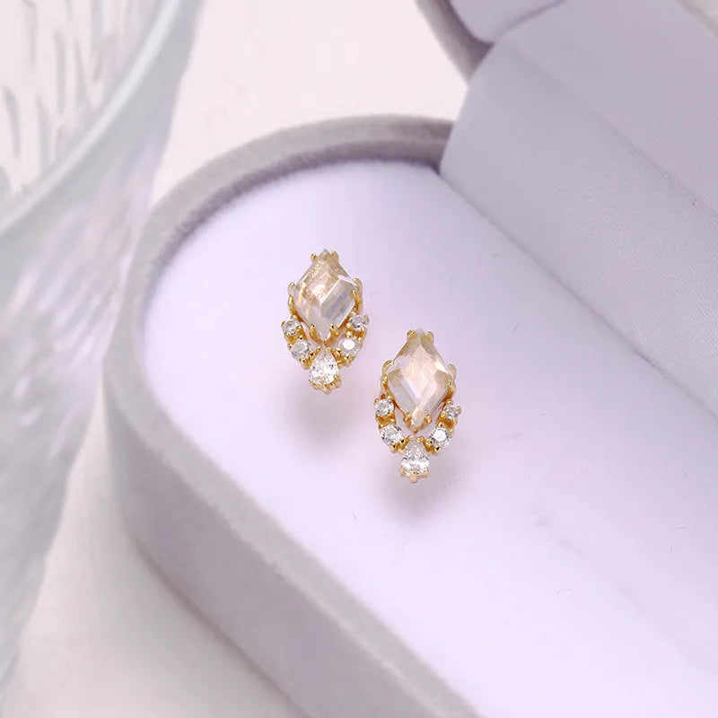 Geometric silver earrings with natural white crystal studs