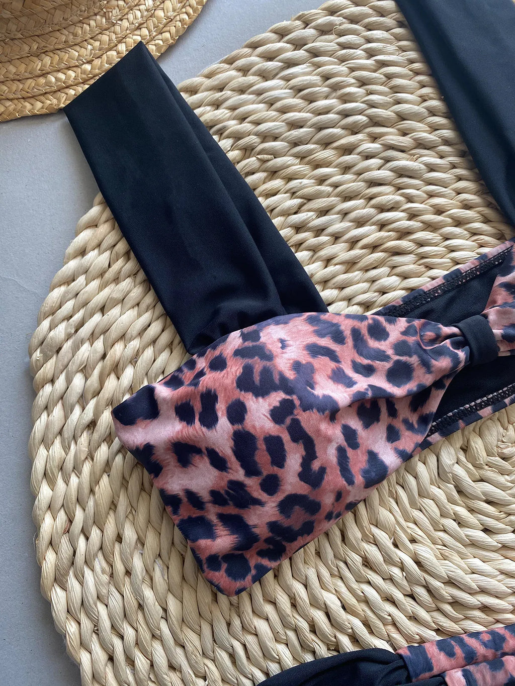 Women's leopard print tube top bikini set with matching T-pants on a mannequin.