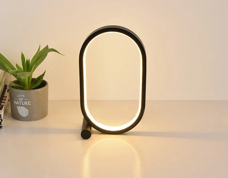 Oval acrylic desk lamp with touch controls, USB charging, and energy-efficient LED lighting