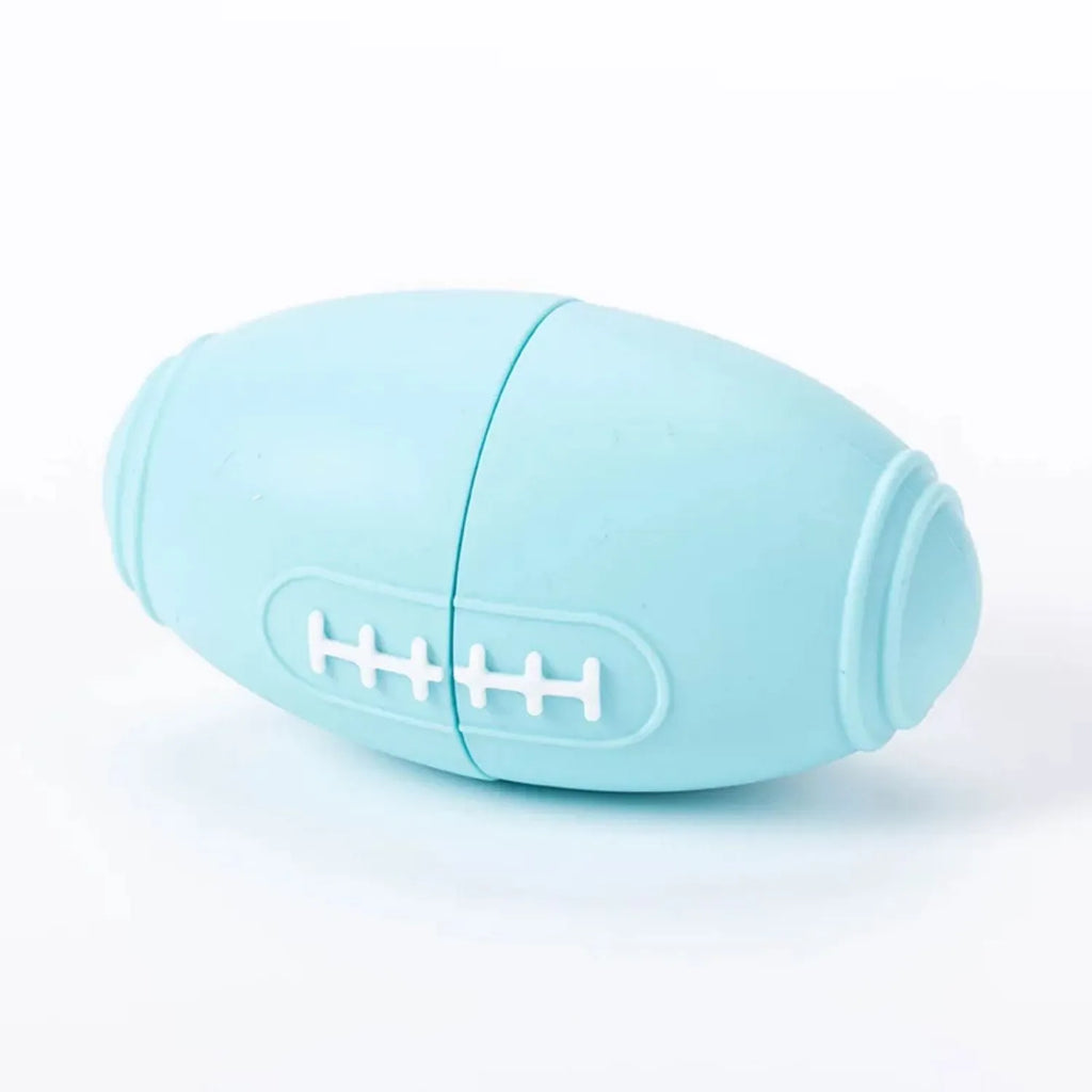 Blue silicone rugby ball dog toy with a hollow centre for holding treats.