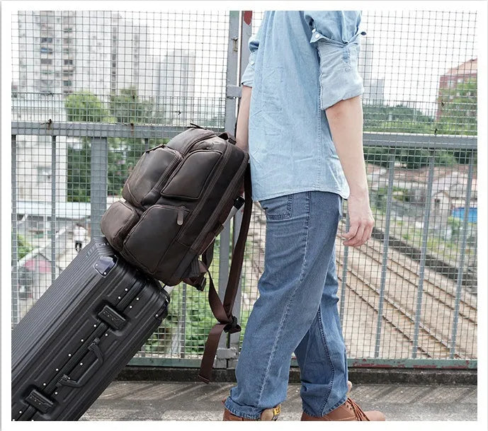 Dark brown retro leather backpack for men with a 17-inch laptop compartment open.