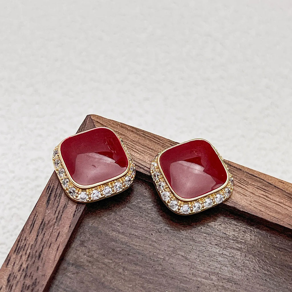 A pair of retro red square geometric alloy earrings with an inlaid design detail.